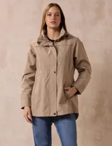 Campera impermeable color gris claro, marca Gallery. Tiene abertura central con cierre oculto y botones a presión, bolsillos delanteros y capucha plegable en el cuello.