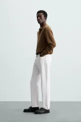 Polo marrón de corte relaxed fit, tejido en punto de algodón. Tiene cuello solapa con cierre frontal de botonadura, manga larga y acabados en rib.