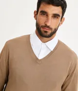 Suéter azul marino de tejido de punto liso, con cuello V y mangas largas.