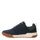 Zapatos bajos Caterpillar modelo Hex Ready Lo, color azul marino, con capellada de nobuk o cuero sintético. Suela gruesa bicolor, con entresuela color crema y suela exterior de goma marrón con diseño de hexágonos. Cordones grises con puntos blancos y detalles en amarillo claro en la lengüeta y tirador trasero.