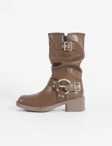 Botas marrones de caña media con hebillas plateadas y taco bajo. Fabricadas en cuero vegano.