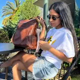 Mochila marrón de eco-cuero con monedero de regalo. Tiene capacidad para una laptop de 15.6 pulgadas.