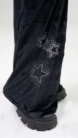 Pantalón de jogging negro de terciopelo con cintura elástica ajustable con cordón y apliques de estrellas con brillos.