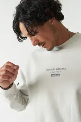 Buzo verde oliva de felpa con cuello redondo, puños y cintura acanalados. Estampado frontal con la frase "The Real Balance" en letras blancas y logo de la marca Mistral.