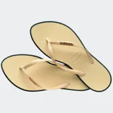 Ojotas Havaianas Slim Point color naranja con borde fucsia y logo fucsia en la tira.