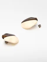 Par de aros circulares con diseño bicolor, mitad color crema y mitad con efecto marmolado en tonos marrón y dorado. Cierre con broche.