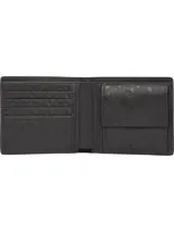 Billetera de cuero granulado negro, con diseño plegable y logo de Tommy Hilfiger en la parte inferior.