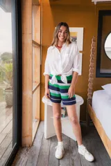 Short tejido a crochet con cintura elástica y diseño a rayas horizontales en verde, azul y blanco.