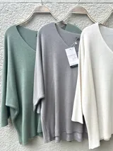 Sweater tejido fino italiano color crudo, con escote en V y mangas 3/4. Diseño holgado y liviano.