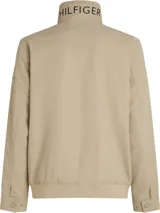 Campera Tommy Hilfiger color beige con cuello alto y cierre de cremallera. Tiene dos bolsillos laterales, detalles distintivos de la marca y logo engomado bordado en la manga.