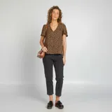 Blusa marrón con estampado animal print, escote en V y mangas cortas con volantes.