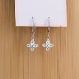 Caravanas en plata 925 con dije colgante en forma de flor adornada con zirconias.