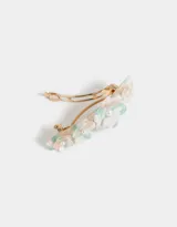 Hebilla francesa para el pelo con apliques de flores de acetato con diseño marmoleado en tonos pastel y perlas artificiales.
