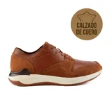 Zapato de vestir acordonado color negro, de cuero, con suela blanca y detalles en gamuza.