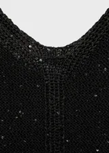 Top negro de tejido de punto con detalle de lentejuelas y tirantes finos.
