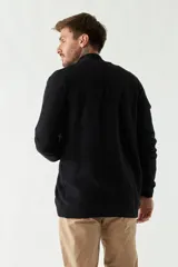 Campera tejida negra para hombre, con cuello alto y cierre frontal.