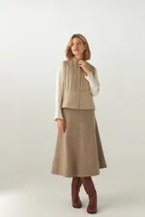 Chaleco entallado corto con cierre frontal y diseño de alforzas en la parte delantera y trasera. Confeccionado en lana fina sin teñir, diseñado exclusivamente por Don Baez.