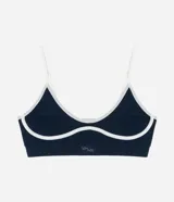 Soutien deportivo azul con breteles finos ajustables, base larga y detalles contrastantes en color blanco.