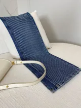 Pantalón de jean azul con corte wide leg, strass plateado y abertura lateral.