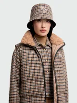 Sombrero tipo bucket reversible con estampado a cuadros en tonos marrón, beige y negro.