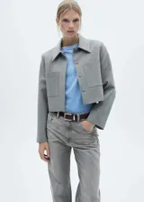 Pantalón de jean gris de corte recto, tiro medio, con cierre de cremallera y botón, trabillas, dos bolsillos delanteros, bolsillo monedero y dos bolsillos de parche en la parte posterior.