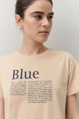Remera blanca de manga corta con estampado tipográfico azul en el frente.
