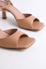 Sandalia plateada de fiesta con diseño elegante y minimalista. Presenta punta cuadrada, tira delantera ancha y pulsera al tobillo con hebilla regulable, que brinda firmeza y comodidad.