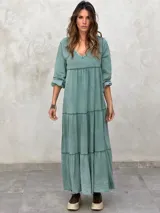 Vestido largo color morado, con escote en V, mangas largas y corte escalonado.