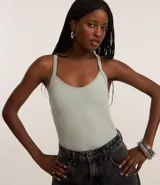 Body femenino sin costura, color verde claro, con escote redondo, breteles que se cruzan en la espalda y detalle de tejido texturizado en los laterales.