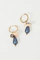 Aros de argolla dorada con dije colgante en forma de hongo de resina roja y blanca con incrustaciones de strass.