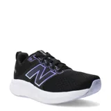 Championes de running New Balance modelo 460 para mujer, color negro con malla transpirable. Presenta el logo 'N' lateral en tono violeta con borde iridiscente y entresuela blanca gruesa.