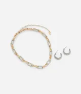 Conjunto de collar y aros de metal con diseño bicolor dorado y plateado. El collar es de cadena con eslabones grandes y los aros son tipo argolla con textura.