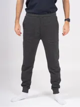 Pantalón babucha deportivo unisex color gris oscuro, de tiro alto y con puños.