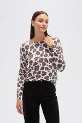 Sweater de tejido de punto, color crema, con estampado floral en tonos rosados y marrones. Presenta cuello redondo y mangas largas.