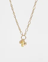 Collar corto dorado con cadena de eslabones y dijes colgantes: taxi amarillo, manzana y pretzel dorados.