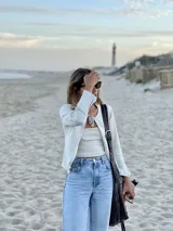 Saco de punto color negro con escote en V y lazo de ajuste frontal, de mangas largas acampanadas.