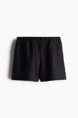 Short negro de lino con cintura elástica y cordón de ajuste.