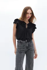 Blusa blanca de lyocell y algodón, con escote fruncido con volados y lazos.