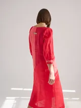Vestido midi de lino color lila con escote en V y mangas 3/4 abullonadas con puño elástico.