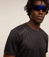 Remera deportiva gris con cuello redondo, mangas cortas, estampa heat print y detalle en los hombros. Confeccionada en tejido de malla con tecnología Dry.