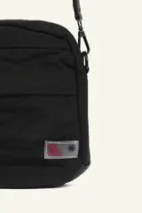 Bandolera negra de poliéster con correa ajustable para usar cruzada o al hombro. Cuenta con compartimentos con cierre y detalles de cordones en los cierres.