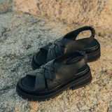 Sandalias de cuero vacuno color marrón, con tiras anchas cruzadas en el empeine, elástico en el talón y doble suela de goma deportiva.