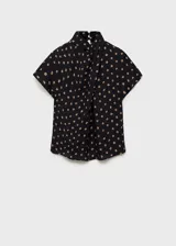 Blusa negra con estampado de lunares color beige, de manga corta y cuello alto con detalle drapeado.