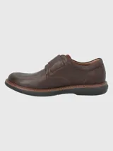 Zapato de cuero negro con ajuste de velcro, suela de goma EVA y plantilla de cuero y algodón orgánico.