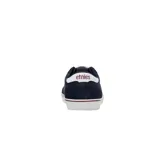 Championes urbanos Etnies Calli Vulc, con capellada combinada en lona gris y gamuza verde oscuro, logo blanco en el lateral, detalles en naranja y suela vulcanizada blanca.
