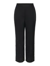 Pantalón negro de corte ajustado con tiro alto, fit relajado y detalle de strass en la parte inferior.