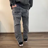 Pantalón de jean gris oscuro, corte mom, de tiro alto y pierna recta.