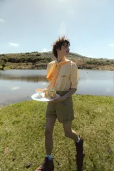 Short unisex color verde con rayas verticales, tiro alto, pinzas y bolsillos.