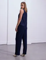 Conjunto de pantalón, blusa y chaqueta de encaje azul marino, marca RM Richards. La blusa es de encaje con escote redondo. El pantalón es de seda fría con cintura elastizada. La chaqueta es de encaje con mangas 3/4.