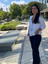 Camisa azul marino de manga larga con cuello camisero y detalle de volados superpuestos en el frente.